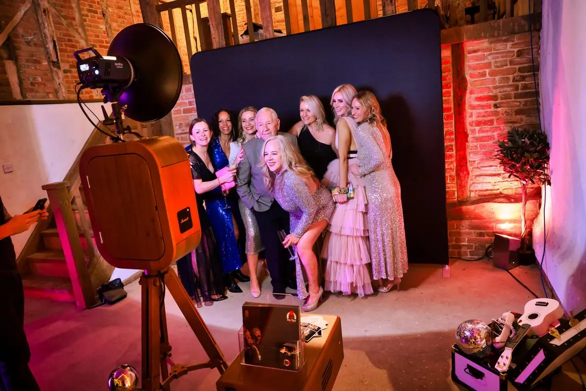 Wedding guests posing in front of the handcrafted Beau Booth
