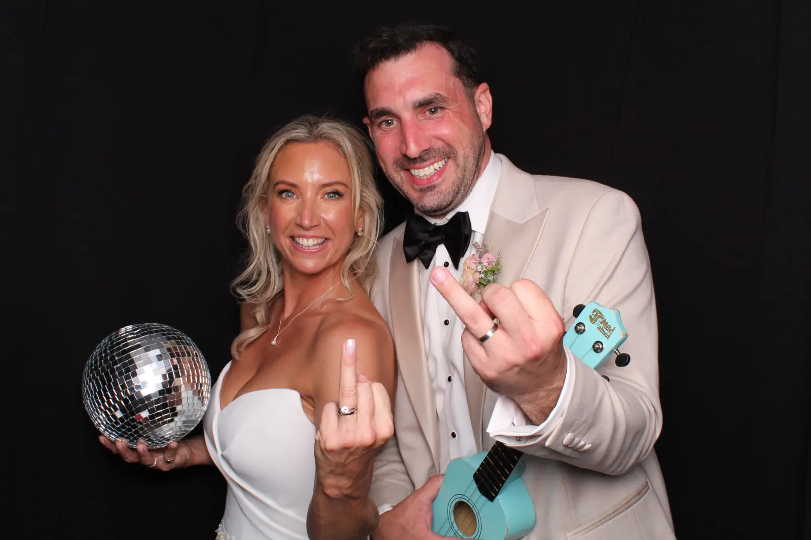 A newly married couple enjoying the Pro-Pose photo booth